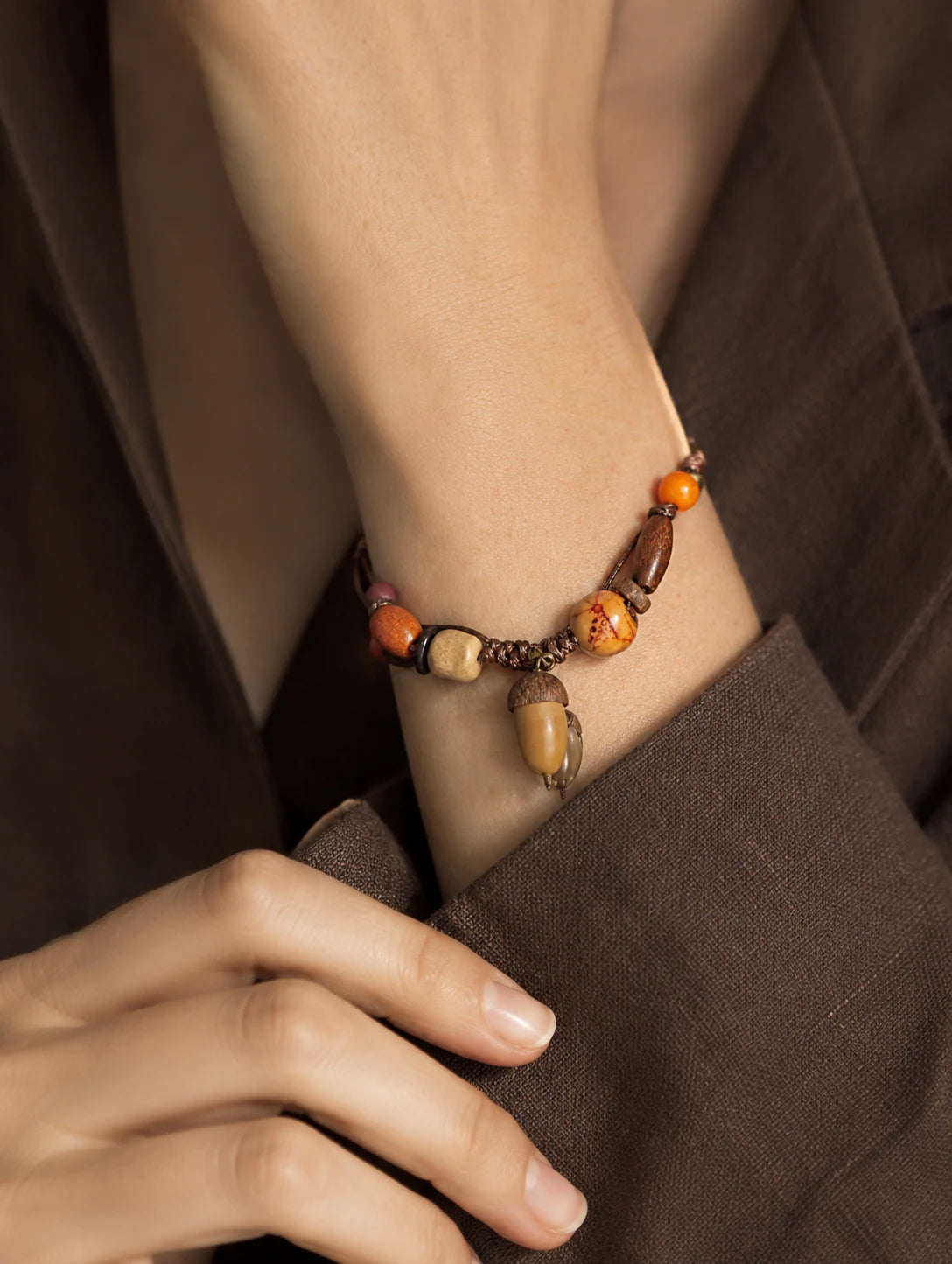 Close-up of a model styling a woodland-inspired bracelet